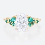 1.5ct Oval Cut Lab Diamond Engagement Ring with Lab Emerald Side Stone Ring in Yellow Gold