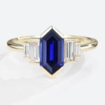 Long Hexagon Cut Lab Grown Sapphire with Moissanite Side Stone in yellow gold