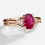 Oval Cut Lab Grown Ruby​​ Ring Set with Curved Diamond Wedding Band