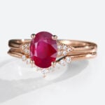 Oval Cut Lab Grown Ruby​​ Ring Set with Curved Diamond Wedding Band