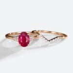 Oval Cut Lab Grown Ruby​​ Ring Set with Curved Diamond Wedding Band