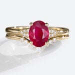 Oval Cut Lab Grown Ruby​​ Ring Set with Curved Diamond Wedding Band