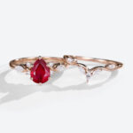 Rose Gold 1.2ct Pear Shaped Lab Grown Ruby Ring Sets with Curved Wedding Band