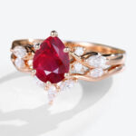 Rose Gold 1.2ct Pear Shaped Lab Grown Ruby Ring Sets with Curved Wedding Band
