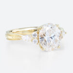 Oval Lab Grown Diamond Engagement Ring with Floral Side Stones in Yellow Gold