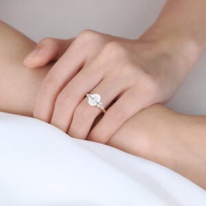 Oval Lab Grown Diamond Engagement Ring with Floral Side Stones in Yellow Gold